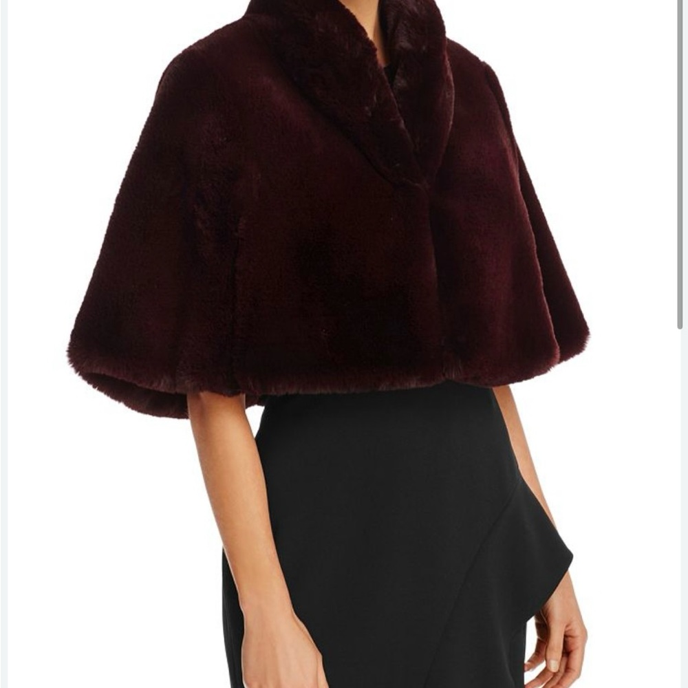 Designed in faux fur, this Betsey Johnson color is wine fits large/xl. New, NWT.